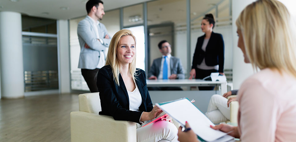 Picture of attractive smiling saleswoman working in office
